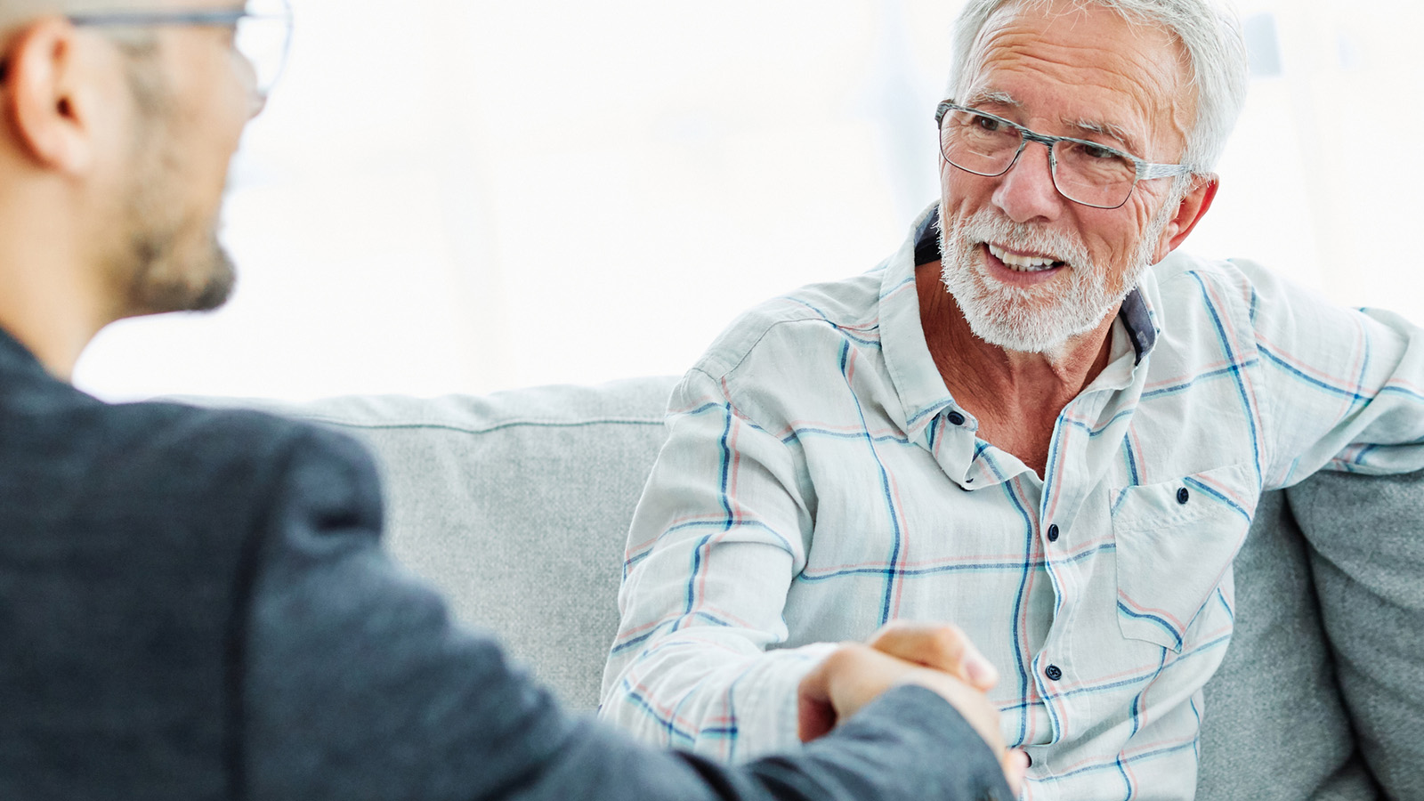 Mark L., Veteran: ‘My payments are lower, and I’m saving thousands! us veteran shaking hangs with loan officer