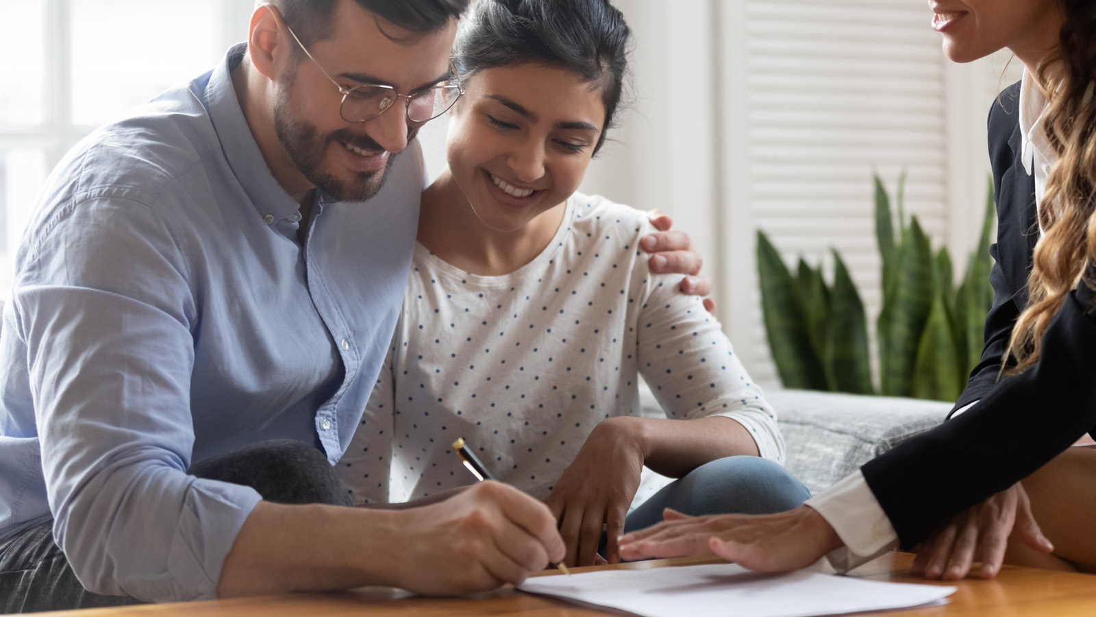 Homeowner signing FHA Streamline Refinance documents with Peoples Bank & Trust Co