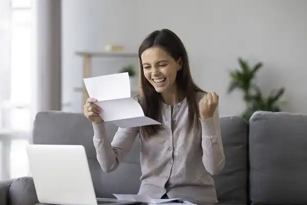 How long does it take to get a loan aprroval? excited girl holding approval letter for a loan